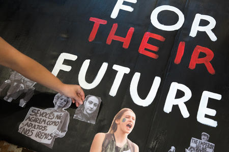 A painted sign reads "for their future"