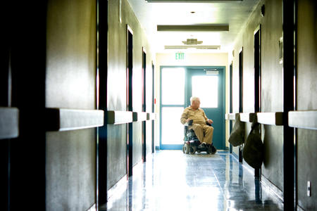 man at the end of a prison hallway