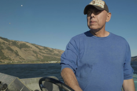 Randy Settler stands on a boat