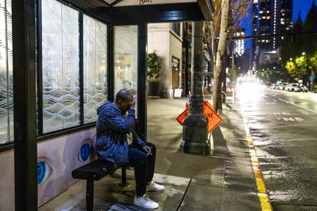 Dwight Williams sitting at a bus stop