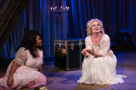 two women sit on the floor on the set of The Tempest