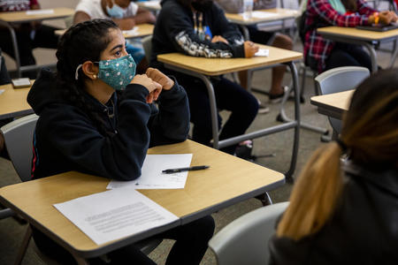 A student listens in a classroom
