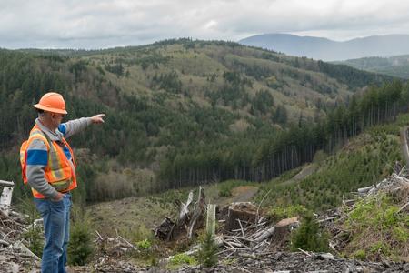 Vince Panesko points to the spot where a dam would be built across the Chehalis river in an attempt to reduce flood damage in the downstream cities of Centralia and Chehalis. (Shane Anderson).