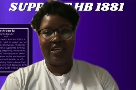 Williams in front of a purple Zoom background with the text definition of 'birth doula'