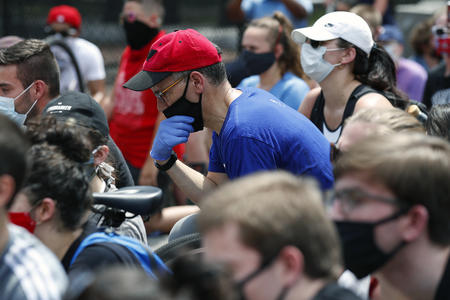 DNC chair Tom Perez in a crowd of protesters