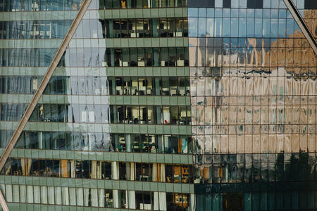a high rise building with offices visible inside
