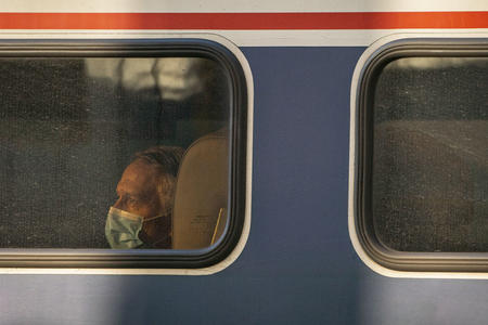 Passenger looks out the window of an Amtrak train