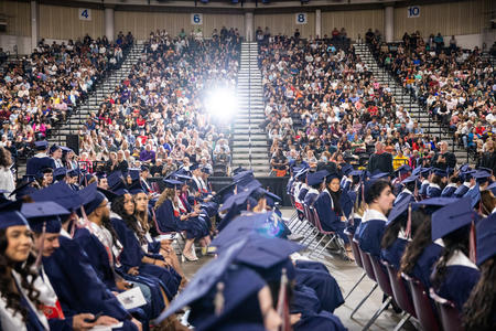 A view of graduation caps and filled seats at Eisenhower High School