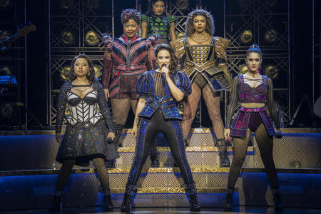 six women dressed in theatrical takes on Elizabethan royalty take a powerful stance on stage