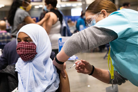 a woman getting a covid shot