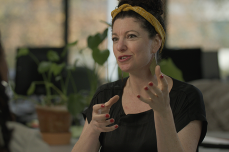 woman gestures with both hands during interview