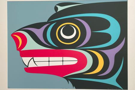 a red, black and light blue painting of a bear's head in the formline tradition