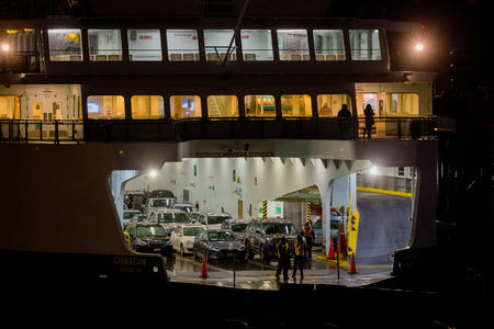 Washington State Ferries workers prepare to remove the netting as the Bremerton ferry arrives in Seattle.