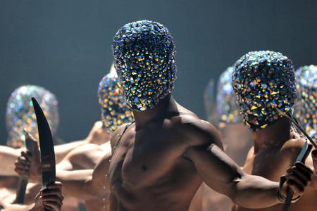 image of a group of dancers on stage wearing sparkly hoods