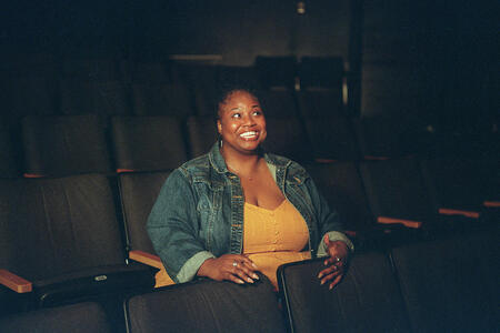 Actor director Shermona Mitchell sits in a Seattle theater