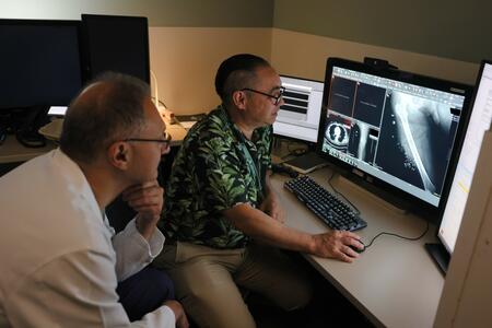 Dr. Sam Arbabi and Ken Linnau look over an x-ray