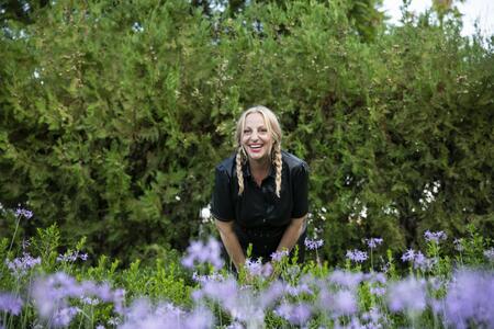 Tali Edut poses in a field of flowers