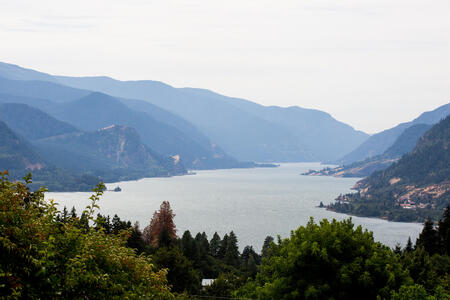 an overhead image of a river with mountains in the background