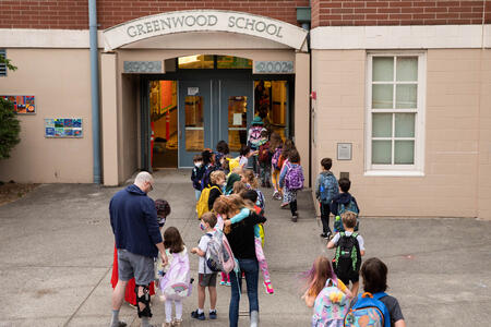 Students enter Greenwood Elementary on the first day of school.