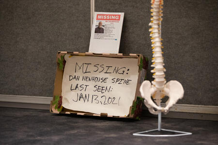 "Missing" poster and model of a spine