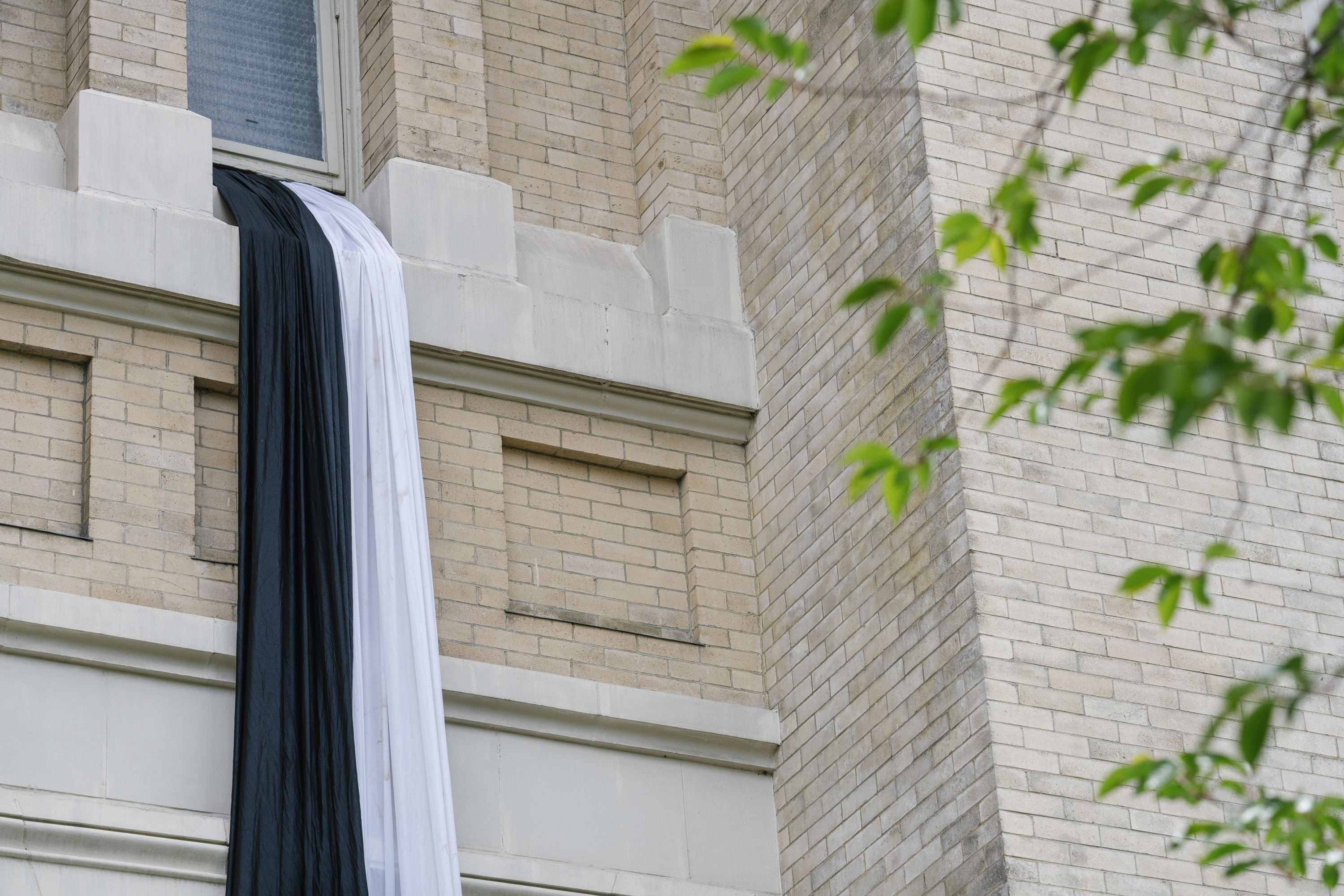 Black and white shrouds hang in mourning from a window at Seattle’s St. James Cathedral after the death of Pope Francis. (M. Scott Brauer / Cascade PBS)